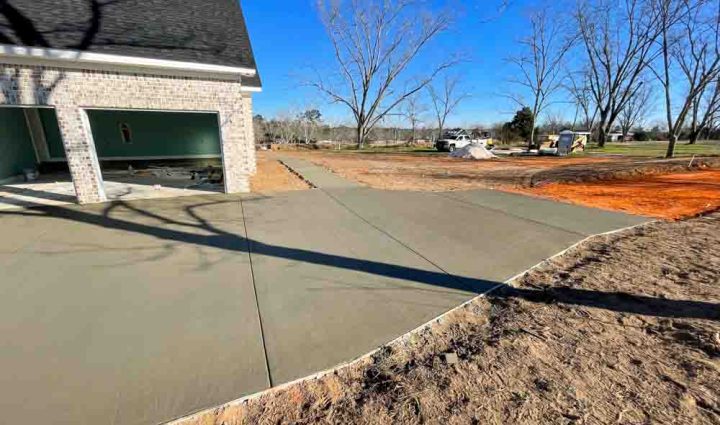Wet Concrete on a driveway leading to a house garage
